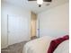 Bedroom with a closet, neutral carpet, and an open door leading to another room at 36467 W Pampoloma Ave, Maricopa, AZ 85138