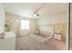 Spacious bedroom with lots of natural light, ceiling fan, and neutral tones at 36467 W Pampoloma Ave, Maricopa, AZ 85138