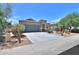 Inviting single-story home with desert landscaping, tile roof, and a wide driveway at 36467 W Pampoloma Ave, Maricopa, AZ 85138