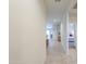 Bright hallway featuring tile flooring that leads to the bedrooms and other living spaces at 36467 W Pampoloma Ave, Maricopa, AZ 85138