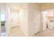 Hallway with tile flooring leads to the laundry room and the front door at 36467 W Pampoloma Ave, Maricopa, AZ 85138