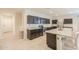 Modern kitchen with a large island, stainless appliances, and dark cabinetry at 36467 W Pampoloma Ave, Maricopa, AZ 85138