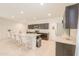 Bright and open kitchen with a large island, plenty of seating, and granite countertops at 36467 W Pampoloma Ave, Maricopa, AZ 85138