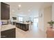 Spacious kitchen with dark cabinets, stainless steel appliances, and granite countertops at 36467 W Pampoloma Ave, Maricopa, AZ 85138