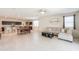Open-concept living area with dining table, kitchen, and comfortable seating with lots of natural light at 36467 W Pampoloma Ave, Maricopa, AZ 85138