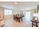 Open-concept living area with dining table and couch with lots of natural light from the window at 36467 W Pampoloma Ave, Maricopa, AZ 85138