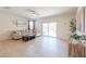 Bright living room with tile floors, slider glass door leading to the backyard, and comfortable seating at 36467 W Pampoloma Ave, Maricopa, AZ 85138