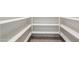 Walk-in pantry with white shelving and tile flooring providing ample storage space at 36467 W Pampoloma Ave, Maricopa, AZ 85138