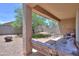 Covered patio with outdoor seating overlooking the backyard at 36467 W Pampoloma Ave, Maricopa, AZ 85138