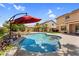 Beautiful backyard pool with a built-in bar, surrounded by lush greenery and patio space for entertaining and relaxation at 3786 S Chaparral Rd, Apache Junction, AZ 85119