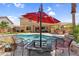 Resort-style backyard with pool, outdoor kitchen, covered patio and lounge seating, perfect for year-round entertaining and relaxing at 3786 S Chaparral Rd, Apache Junction, AZ 85119