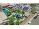 Lush backyard oasis features a sparkling pool, shade, green lawns, and desert landscaping for outdoor enjoyment at 3786 S Chaparral Rd, Apache Junction, AZ 85119