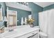 Stylish bathroom with double vanity, teal walls, and shower with curtain at 3786 S Chaparral Rd, Apache Junction, AZ 85119