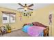 Bright yellow bedroom with a bed, a window, and whimsical decor at 3786 S Chaparral Rd, Apache Junction, AZ 85119