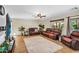 Cozy living room featuring plush leather seating, neutral decor, a ceiling fan, and an area rug at 3786 S Chaparral Rd, Apache Junction, AZ 85119