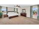 Spacious main bedroom with large windows, neutral walls, and a wooden dresser at 3786 S Chaparral Rd, Apache Junction, AZ 85119