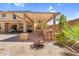 Spacious covered patio with outdoor kitchen, bar, and lounge area, perfect for entertaining in a backyard setting at 3786 S Chaparral Rd, Apache Junction, AZ 85119