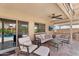 Inviting covered patio featuring plush seating, a ceiling fan, and a view of the sparkling pool at 3786 S Chaparral Rd, Apache Junction, AZ 85119