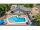 Aerial view of backyard pool with outdoor seating, desert landscaping, and house with a fenced yard at 3964 S Turquoise Dr, Buckeye, AZ 85326