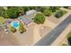 Expansive aerial view showing a sprawling single-Gathering home, mature trees, and a sparkling pool at 3964 S Turquoise Dr, Buckeye, AZ 85326