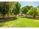 Lush, green backyard with mature trees, offering shade and a serene atmosphere at 3964 S Turquoise Dr, Buckeye, AZ 85326