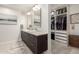 Modern bathroom with double vanity, undermount sinks, tile floors, and a walk in closet at 3964 S Turquoise Dr, Buckeye, AZ 85326