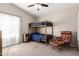 Bedroom with a bunkbed, brown armchair, and natural lighting from window making the space cozy and inviting at 3964 S Turquoise Dr, Buckeye, AZ 85326