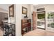 Inviting entryway with tiled floor, wooden door and shelving, next to the kitchen with updated hardware at 3964 S Turquoise Dr, Buckeye, AZ 85326