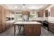 Modern kitchen featuring a large island with seating, stainless steel appliances, and ample cabinets at 3964 S Turquoise Dr, Buckeye, AZ 85326
