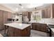 Modern kitchen with stainless steel appliances, center island, and custom cabinetry at 3964 S Turquoise Dr, Buckeye, AZ 85326