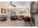 Spacious living room featuring a stone fireplace, comfortable seating, and stylish decor at 3964 S Turquoise Dr, Buckeye, AZ 85326