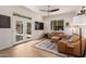 Bright living room featuring French doors, tile floors, and comfortable leather seating at 3964 S Turquoise Dr, Buckeye, AZ 85326