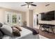 Comfortable main bedroom featuring wood floors, a ceiling fan, french doors, and ample natural light at 3964 S Turquoise Dr, Buckeye, AZ 85326