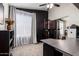 Bright home office with natural light, a large desk, and an exercise area with black accent wall at 3964 S Turquoise Dr, Buckeye, AZ 85326