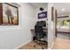 Home office with a modern desk setup, wood flooring, and natural light at 3964 S Turquoise Dr, Buckeye, AZ 85326