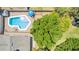 Aerial view of a pristine pool area including a patio and backyard space, surrounded by mature trees at 3964 S Turquoise Dr, Buckeye, AZ 85326