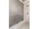 Contemporary shower featuring sleek tiling, a rainfall shower head, and modern fixtures at 3964 S Turquoise Dr, Buckeye, AZ 85326