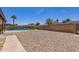 Spacious backyard with gravel and a sparkling pool, perfect for outdoor activities at 4145 W Hayward Ave, Phoenix, AZ 85051