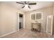 Bedroom featuring a ceiling fan, closet, desk, chair, and mirror at 4145 W Hayward Ave, Phoenix, AZ 85051