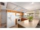 Bright kitchen featuring oak cabinets, white appliances, and an eat-in countertop bar area at 4145 W Hayward Ave, Phoenix, AZ 85051