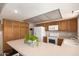 Well-lit kitchen featuring oak cabinets, white appliances, and an island perfect for meal prep at 4145 W Hayward Ave, Phoenix, AZ 85051
