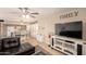 Open-concept living room showcasing tile floors, a TV console, and French doors leading to the backyard at 4145 W Hayward Ave, Phoenix, AZ 85051