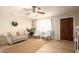 Bright and airy living room with tile flooring, neutral decor, and a ceiling fan at 4145 W Hayward Ave, Phoenix, AZ 85051