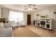 Cozy living room with neutral tones, tile flooring, a ceiling fan, and ample natural light at 4145 W Hayward Ave, Phoenix, AZ 85051