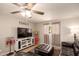 Inviting living room featuring a ceiling fan, dark leather sofas, and a decorative 'Gathering' sign at 4145 W Hayward Ave, Phoenix, AZ 85051