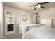 Bright main bedroom featuring a neutral palette, a ceiling fan, and an en-suite bathroom at 4145 W Hayward Ave, Phoenix, AZ 85051