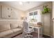Bright office space with a comfortable couch, desk, chair, and natural light from the window at 4145 W Hayward Ave, Phoenix, AZ 85051
