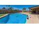 Sparkling blue swimming pool with artificial putting green for outdoor enjoyment at 4145 W Hayward Ave, Phoenix, AZ 85051