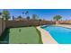 Artificial putting green and pool, offering recreational space in the backyard at 4145 W Hayward Ave, Phoenix, AZ 85051