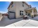 Neutral-colored two-story home with a covered patio and outdoor dining set, along with a backyard shed at 41650 W Barcelona Dr, Maricopa, AZ 85138